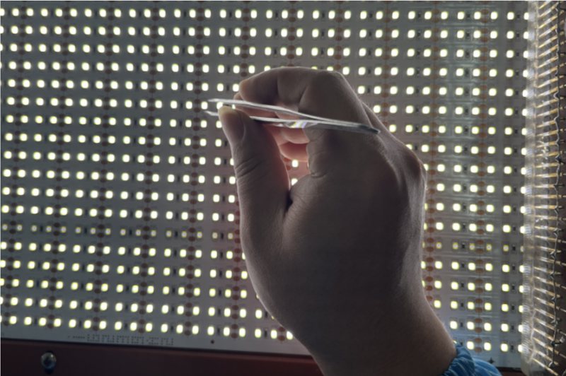 Laying the finished product on the testing shelf, turn on lights to mark the defective such as dead LEDs