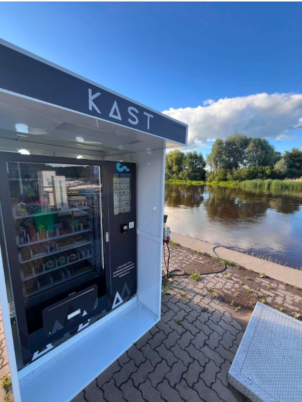 Refrigerated outdoor snack vending machine dispensing cold drinks and packaged snacks in an Estonian public park