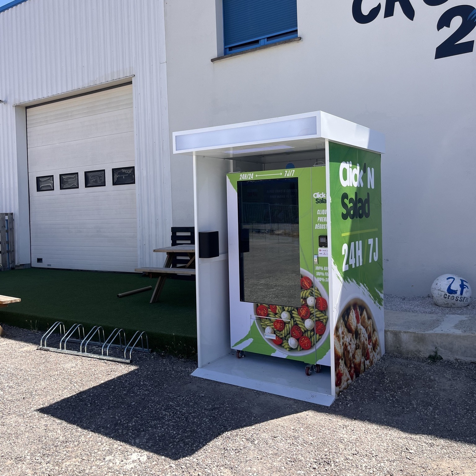 Outdoor elevator food vending machine dispensing fresh ready meal and healthy food boxes safely on a French sidewalk