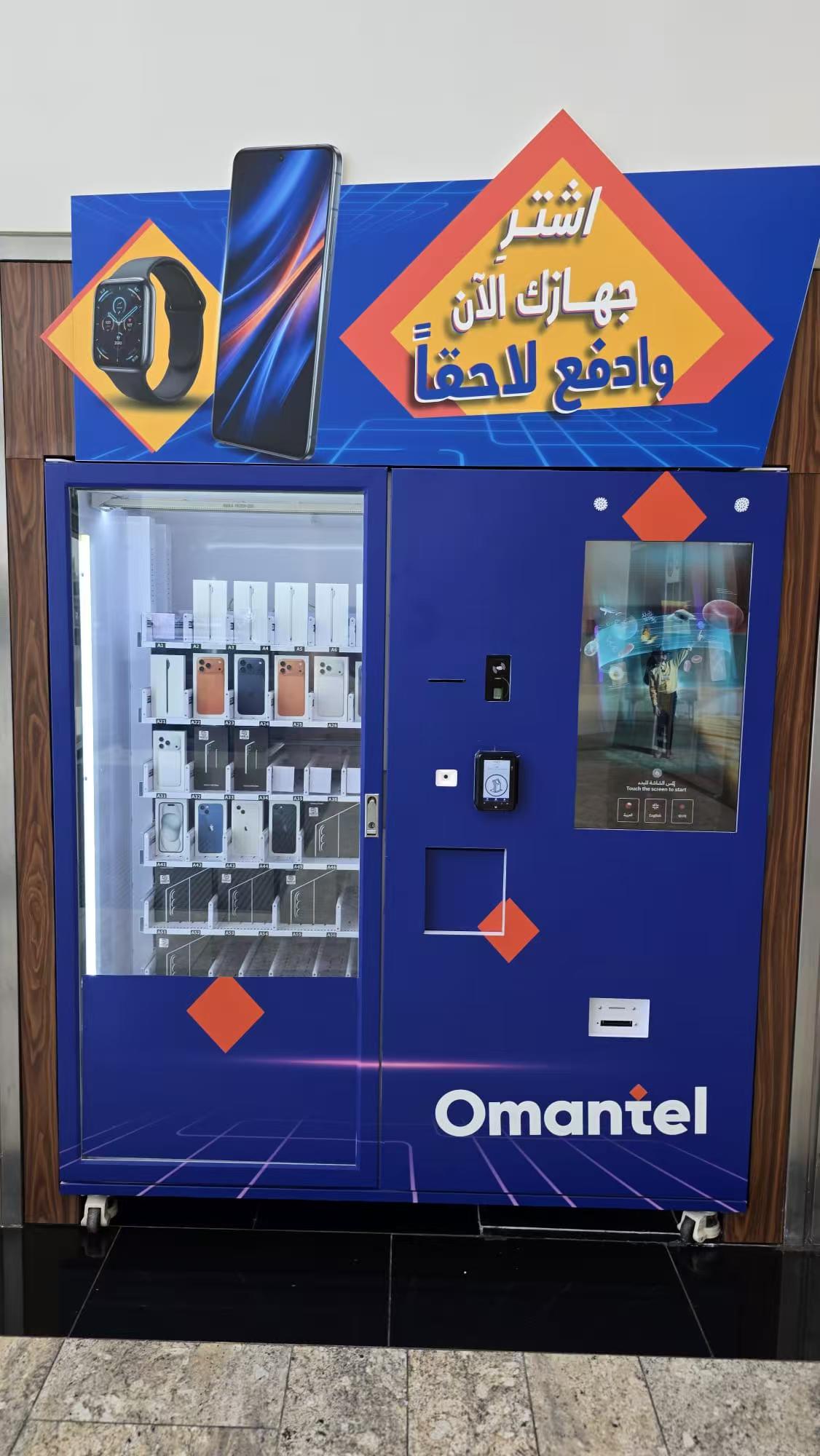 XY-axis elevator phone vending machine dispensing smartphones and charging cables safely in an Oman shopping mall