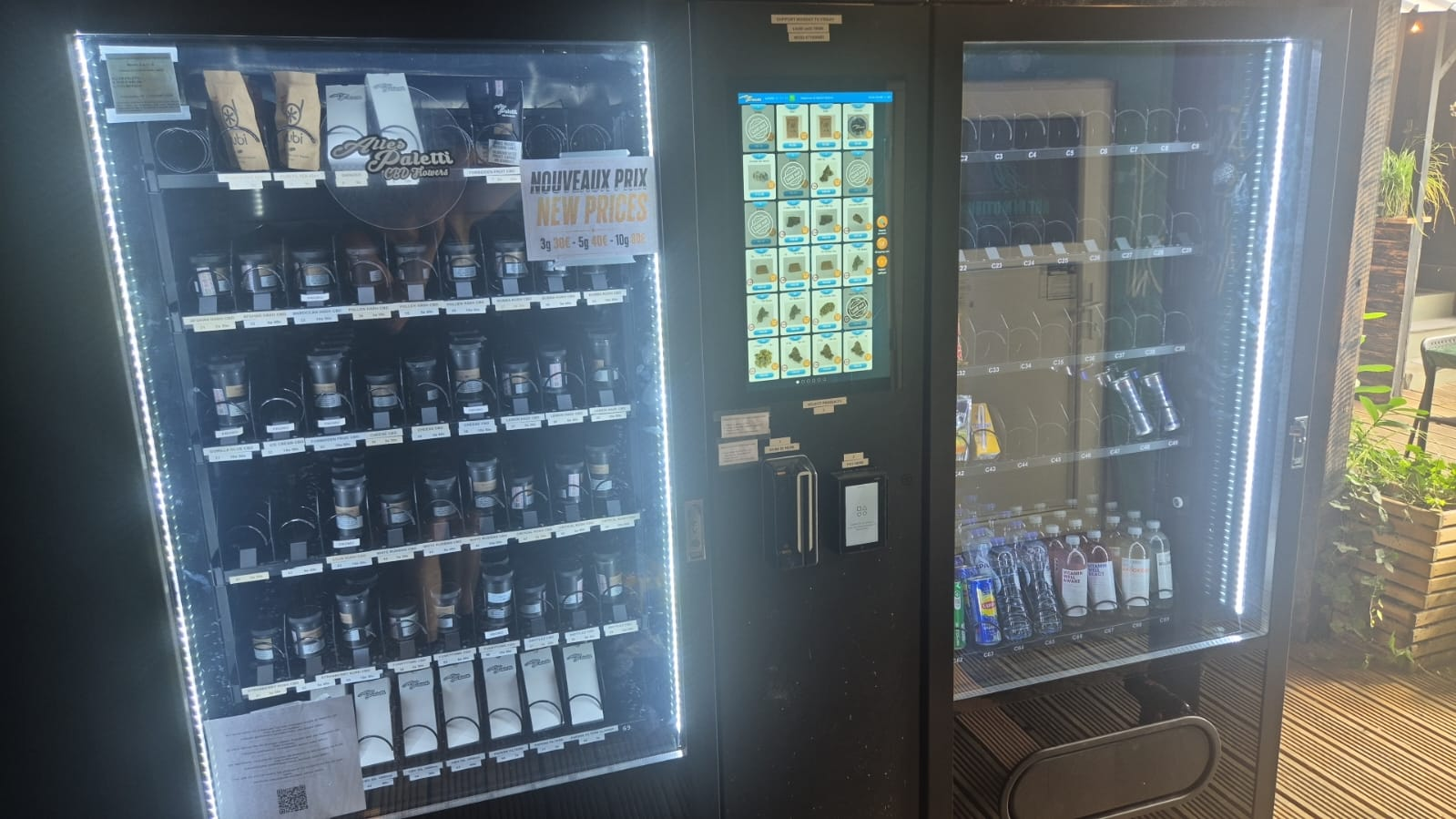 Age-verified CBD vending machine displaying premium wellness drops and recovery balms securely in a Luxembourg hotel lobby