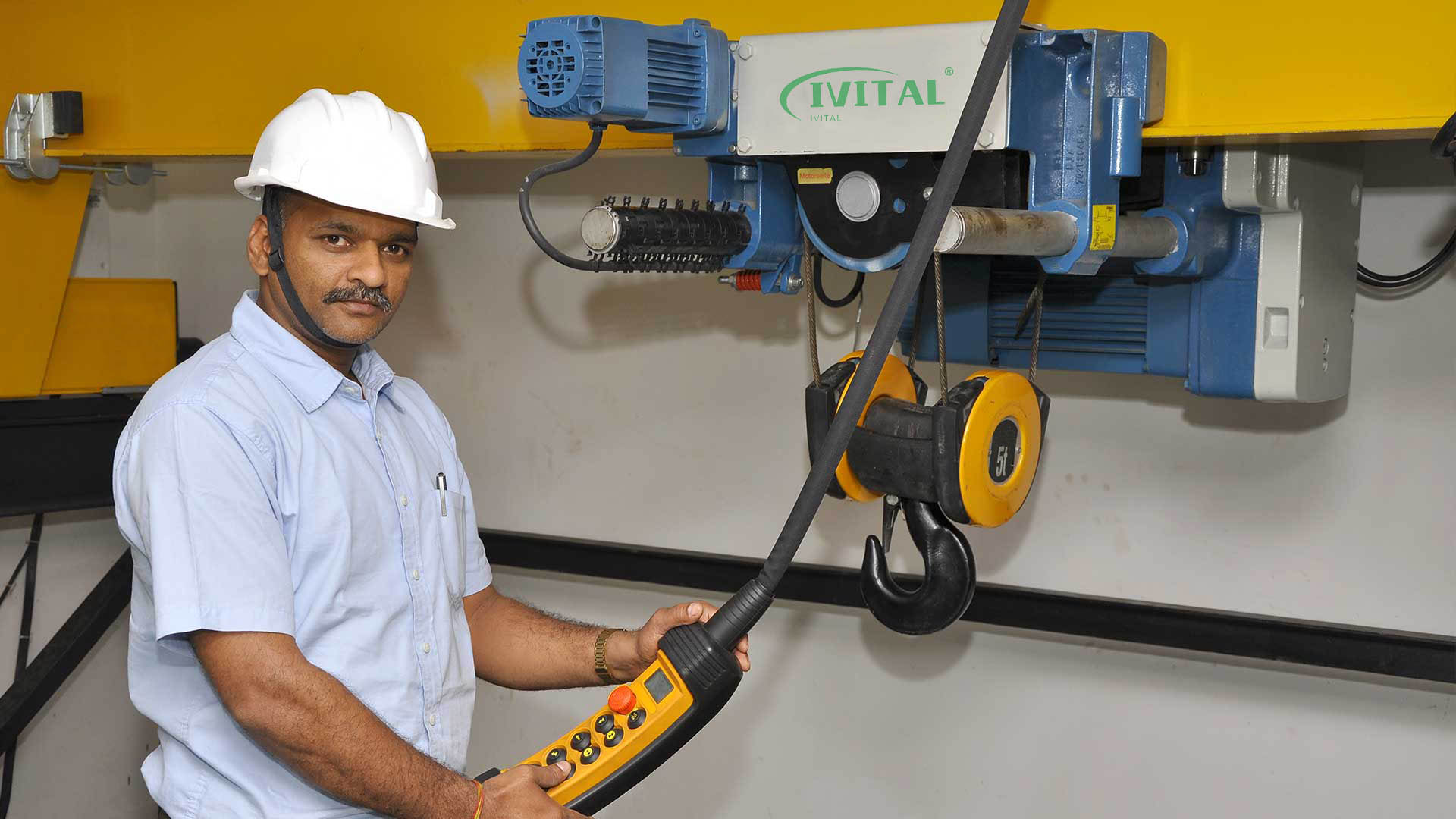 Technician testing hoist power module with multimeter