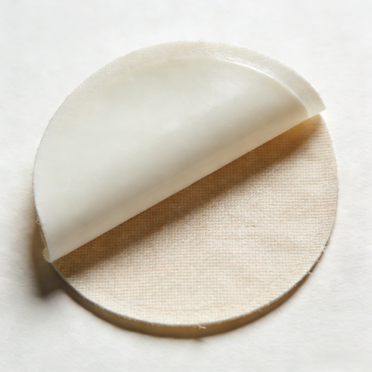 smooth, matte, or slightly shiny layer on the back of the patch