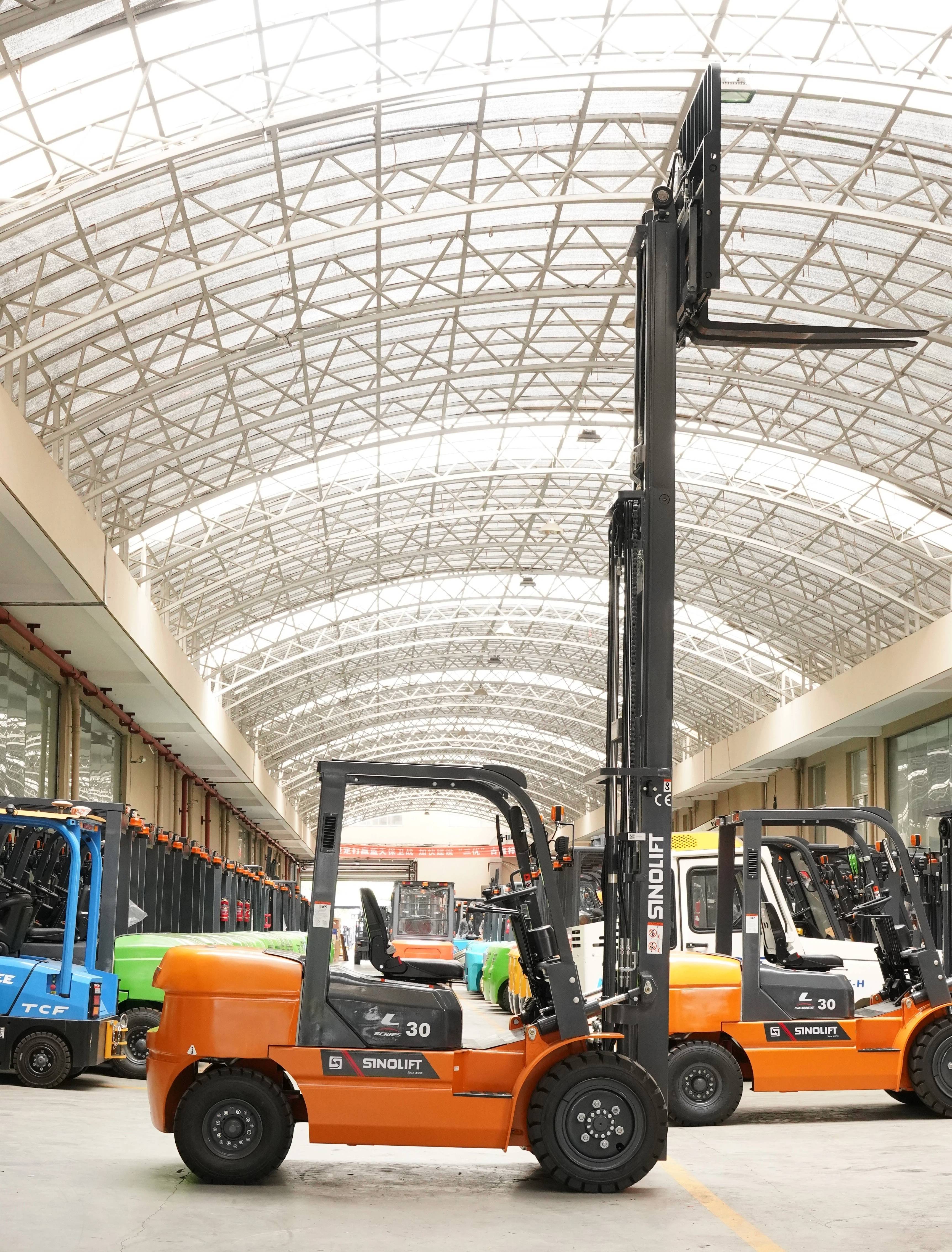 Operator conducting pre-operation safety check on diesel forklift tires and forks