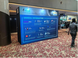 A blue promotional wall at the OGA exhibition