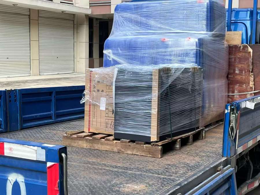 Palletised lithium forklift batteries being loaded onto a truck