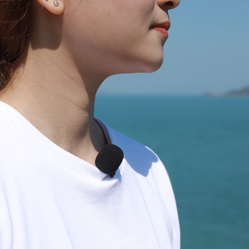 A Person Using an External Microphone While Filming a Video