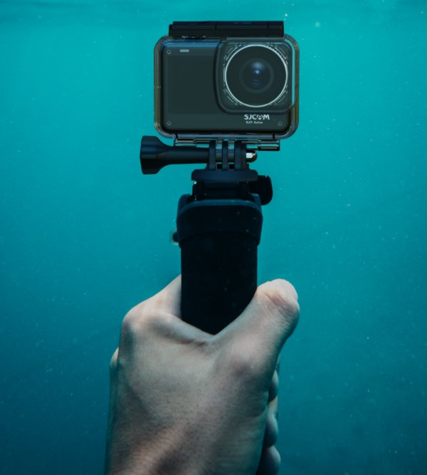 An SJCAM SJ11 Active Action Camera Mounted on a Grip