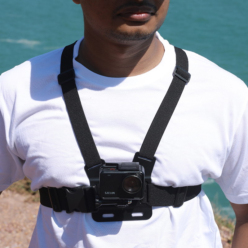 An SJCAM Action Camera with Chest Strap Worn on a Person