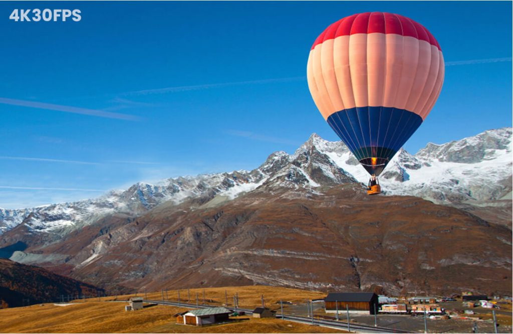 A Colorful Hot Air Balloon Floats in the Highland Sky