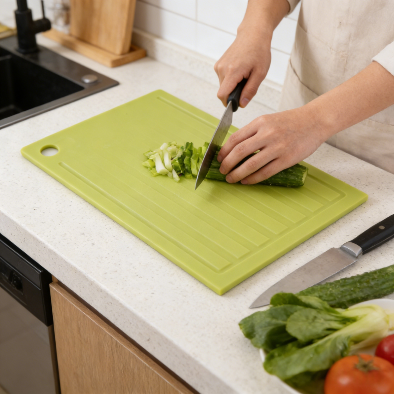 Plastic cutting board used in modern kitchen food preparation