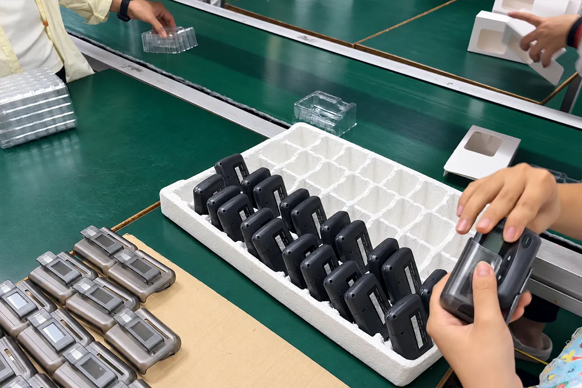WEX staff placing tested W2028 pagers into protective packaging