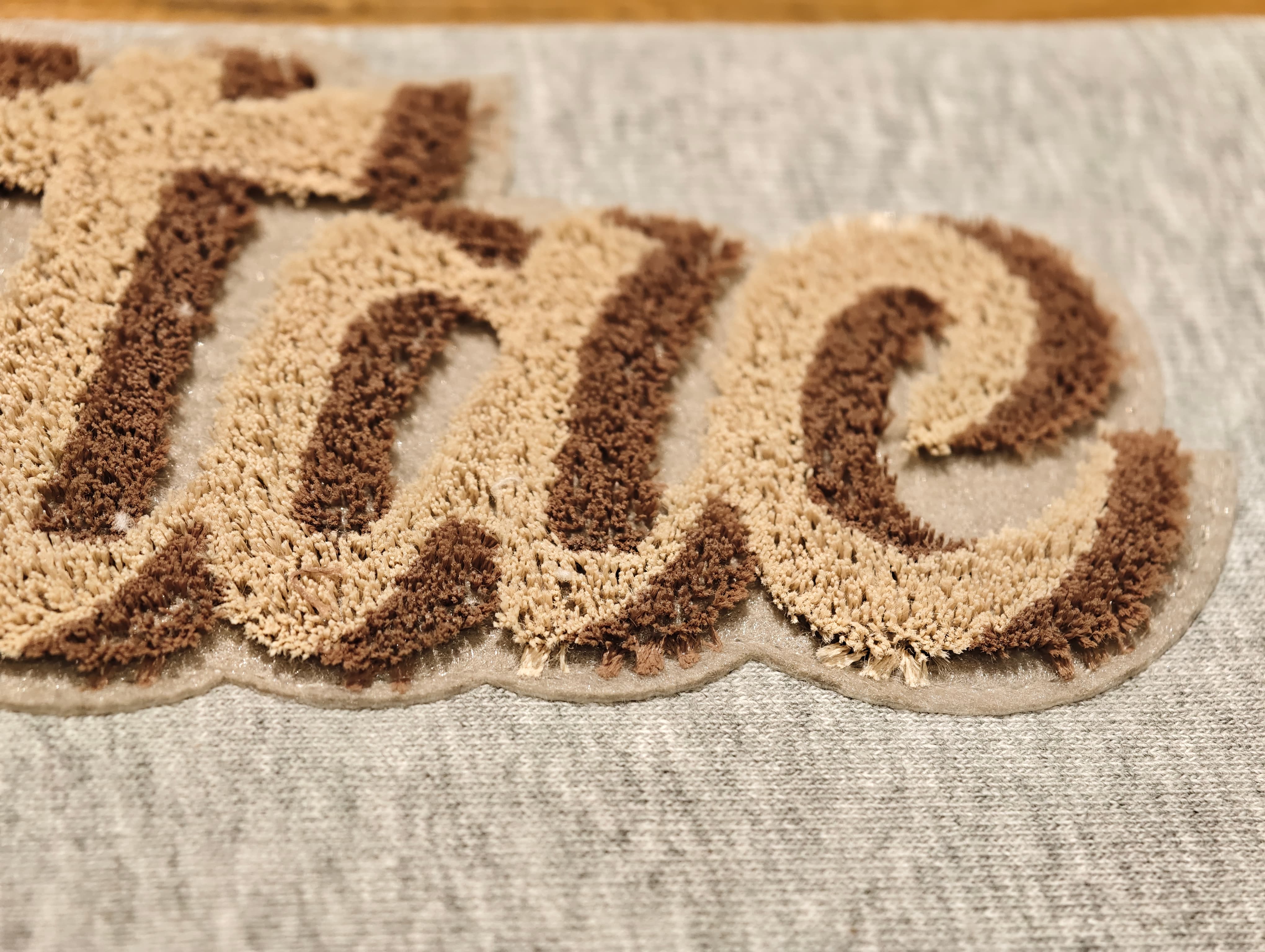 Two-tone cut chenille embroidery with dual-color texture
