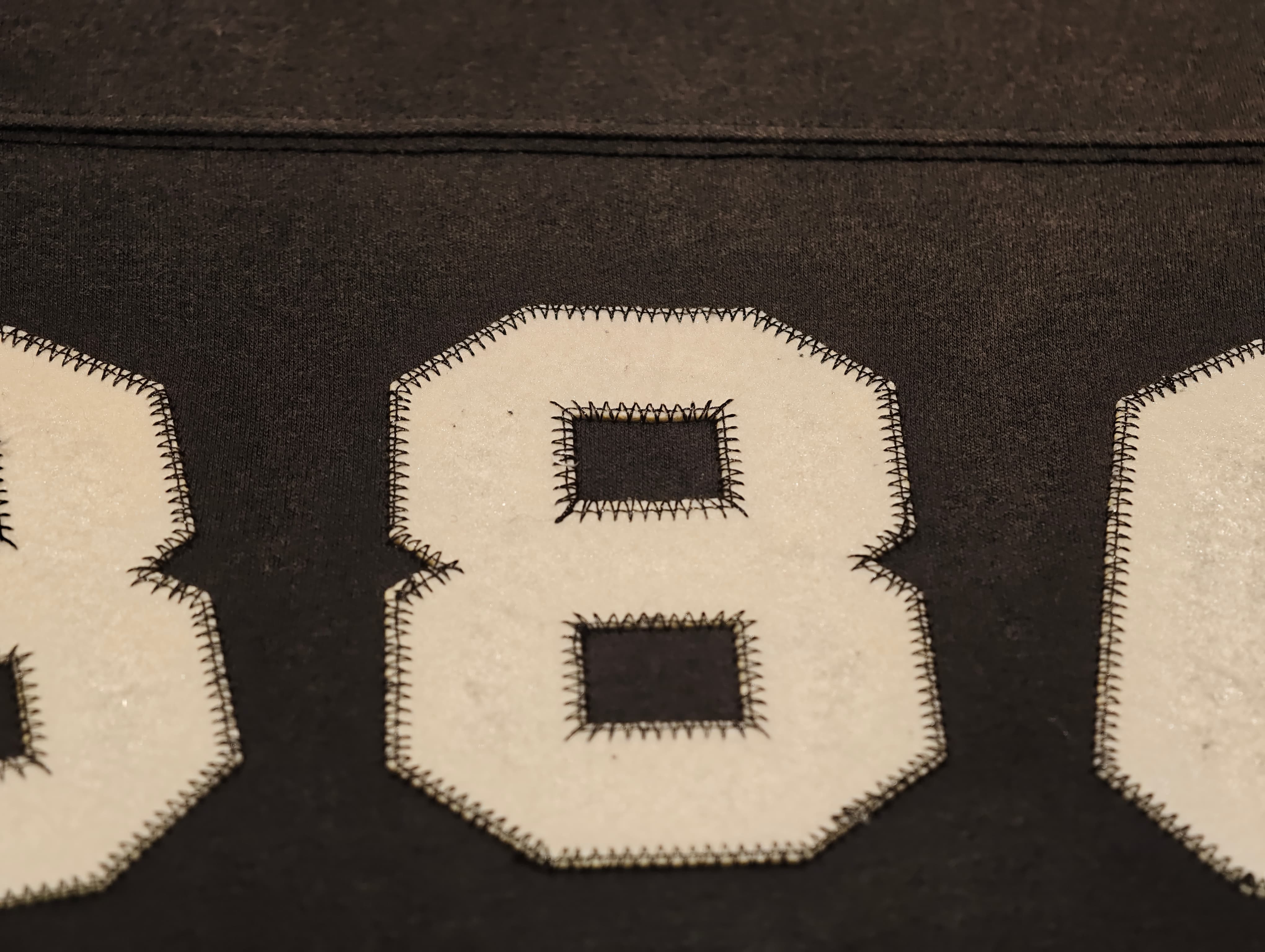 Appliqué embroidery with layered fabric and stitched borders