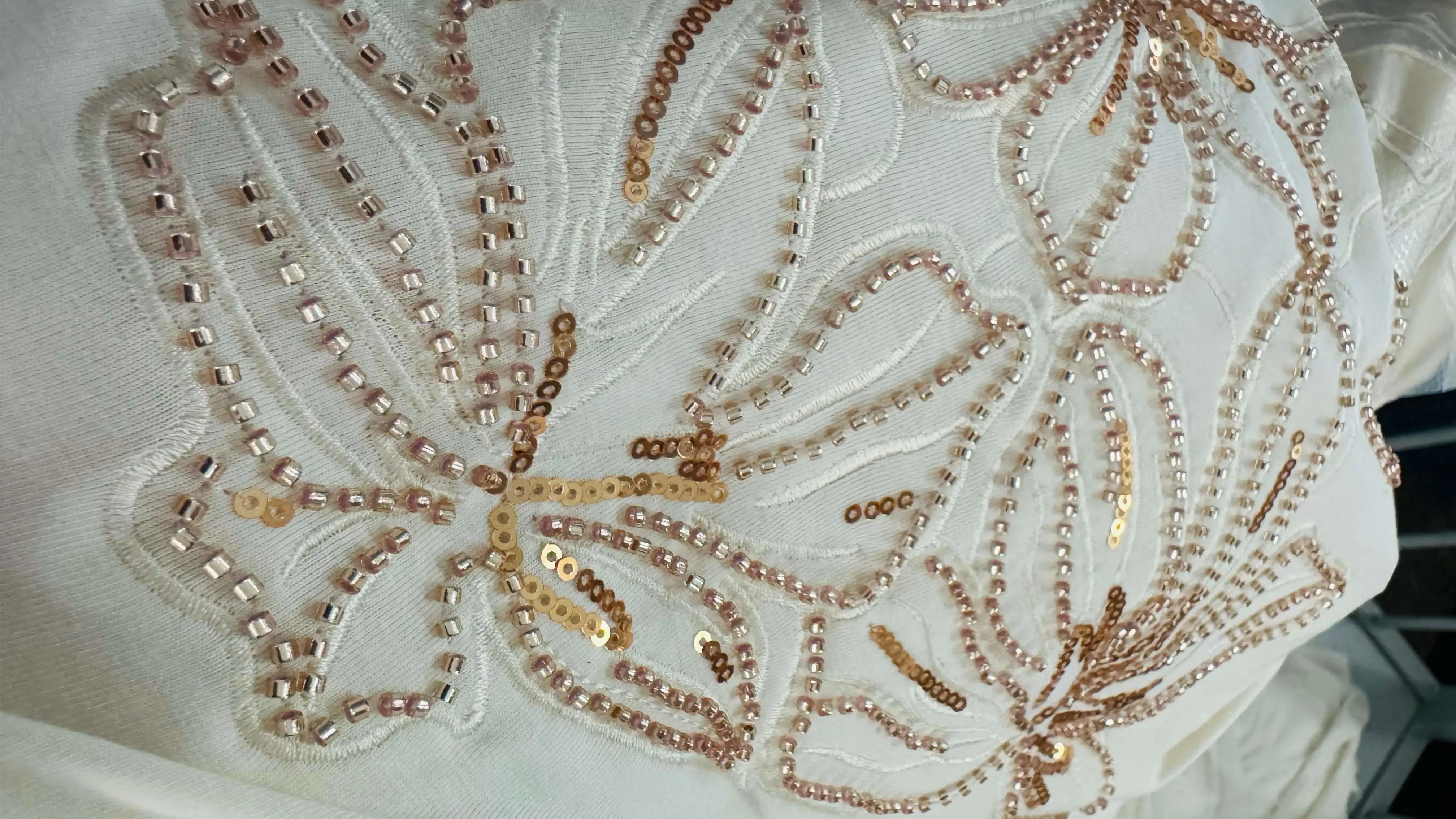 Beading and sequin embroidery with reflective surface detail
