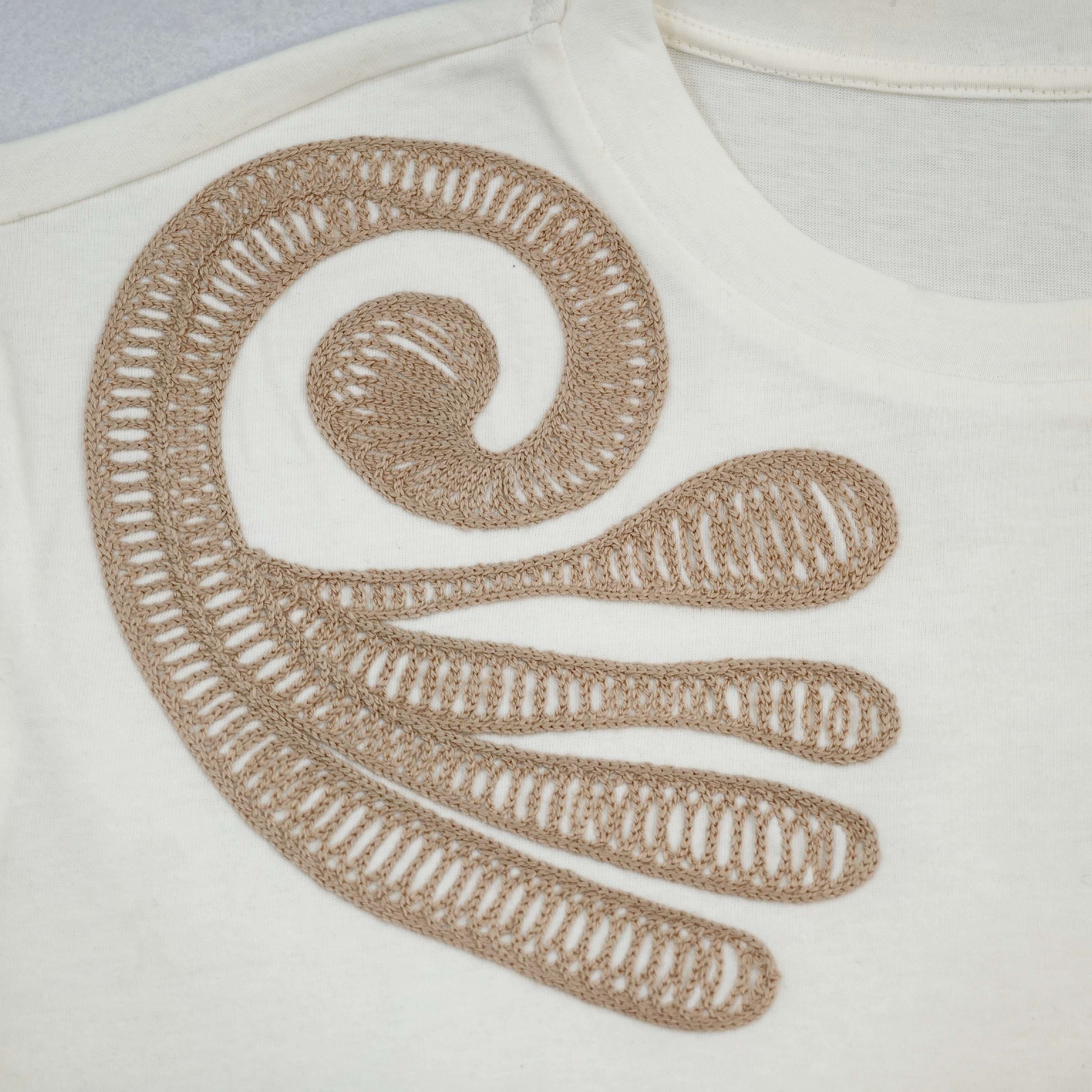 Cord embroidery with raised outlined motif