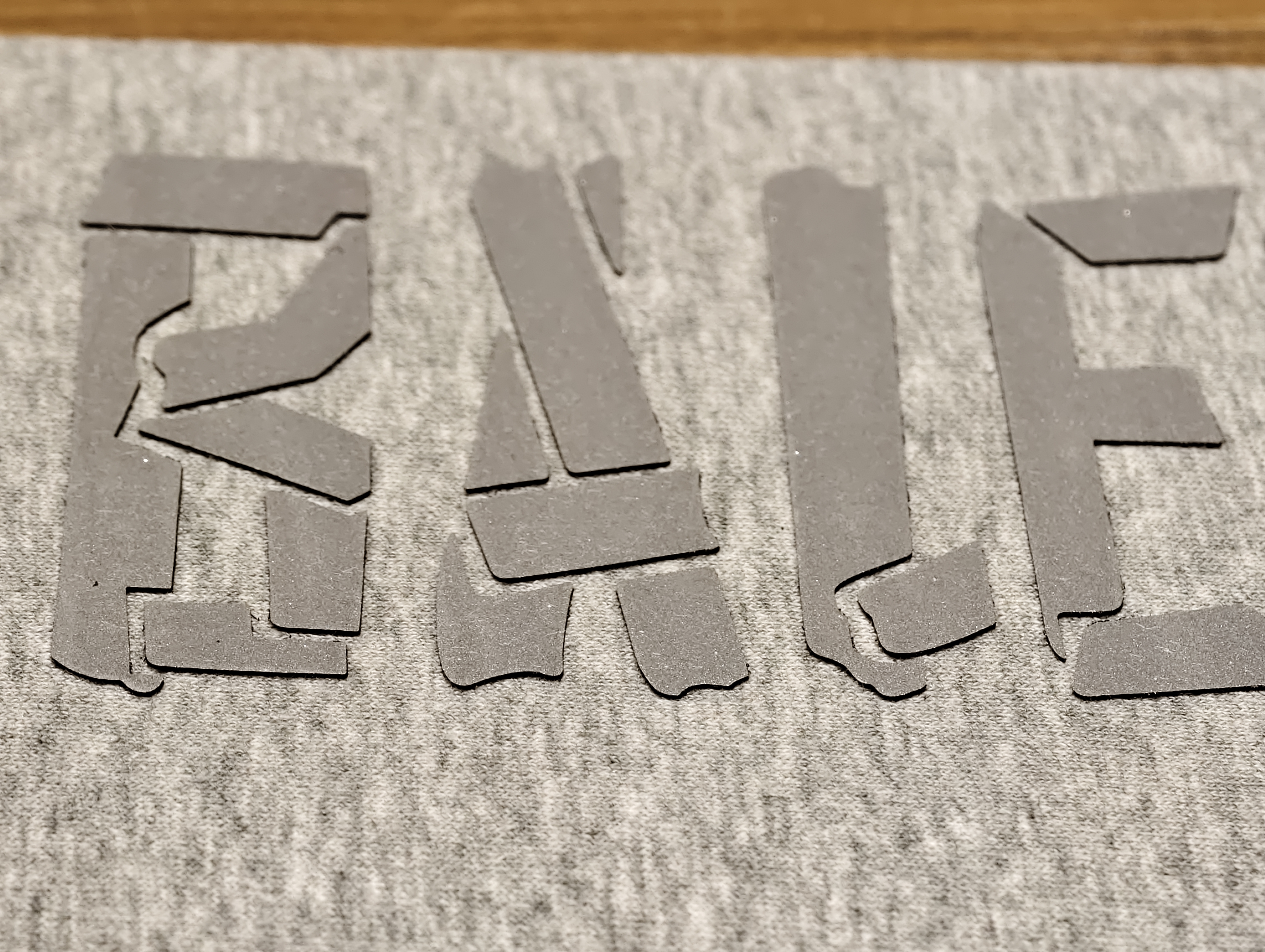 rubber heat transfer print with raised tactile garment lettering