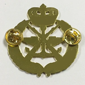 Gold crown and gun lapel pin