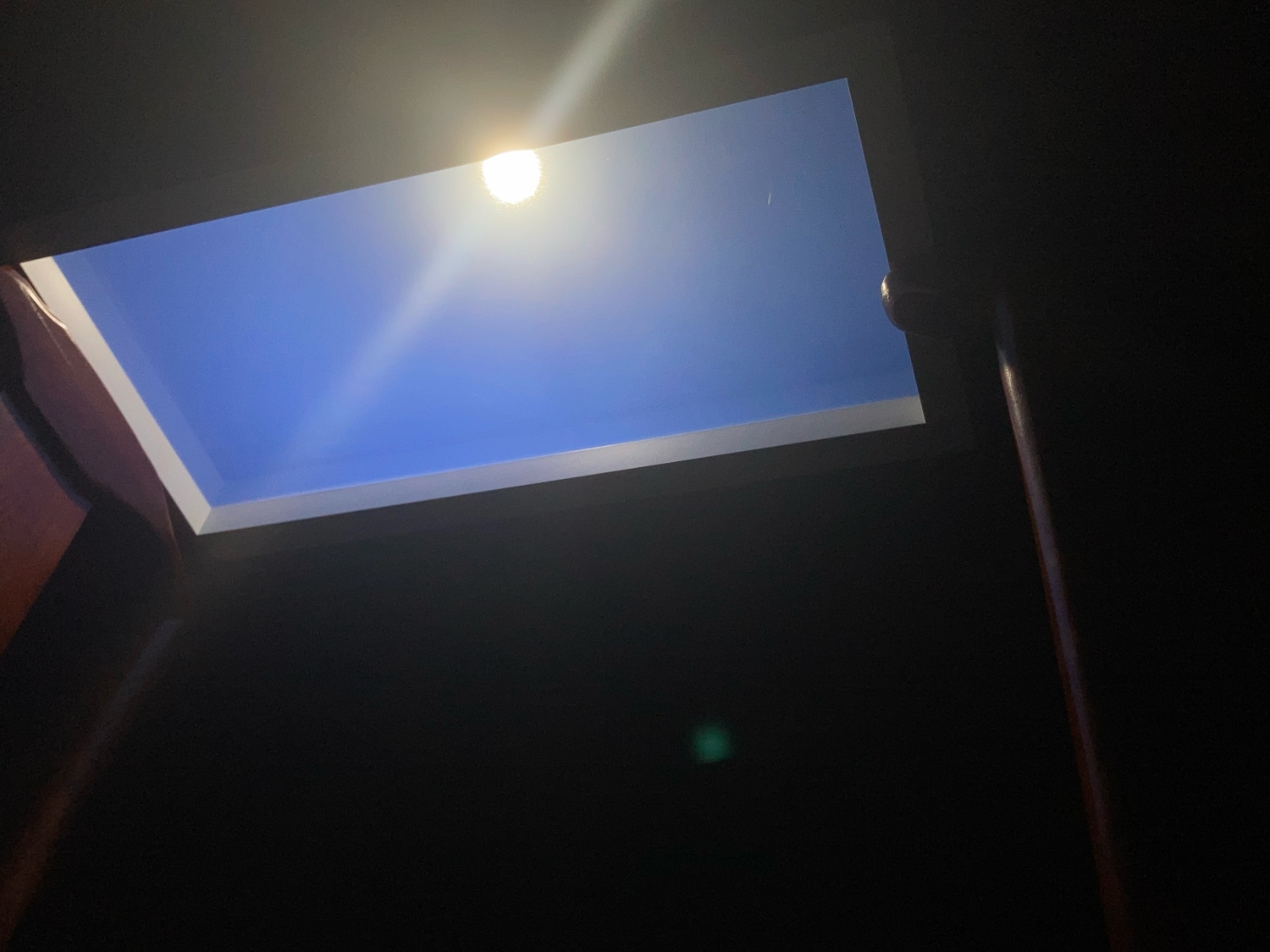 Lumin Sun-in-sky artificial skylight featuring built-in COB artificial sun module, emitting warm directional light beam against a soft blue sky background, designed for lobbies and retail spaces