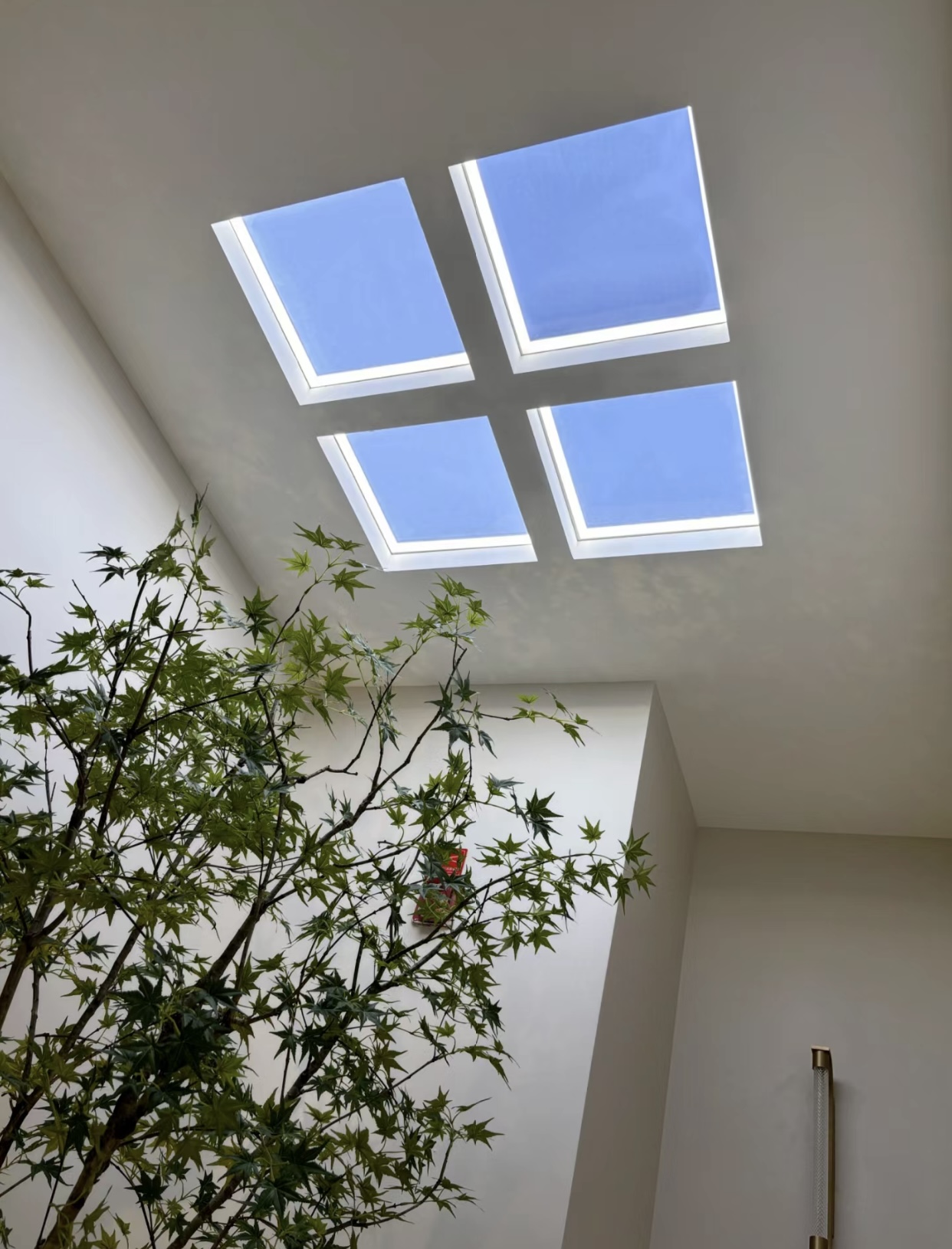 Lumin H50 ultra-thin artificial skylight with 50mm slim profile, featuring tunable white perimeter lighting and central blue sky optical panel, installed in a minimalist office or study room.
