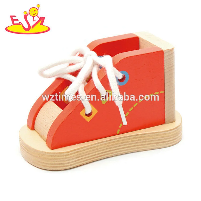 Neues heißes pädagogisches hölzernes Schnürungsschuhspielzeug für das Unterrichten der Kinder, Schuhe W11E069 zu binden