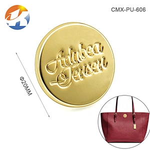 Round With Embossed Logo Brush Bronze Handbag Metal Logo Designs