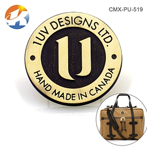 Round With Embossed Logo Brush Bronze Handbag Metal Logo Designs