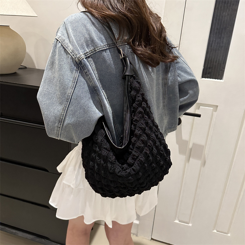 A versatile and chic crossbody quilted bag with a refined quilted pattern and adjustable straps. Perfect for hands-free convenience, whether you're on the go or attending a special event.