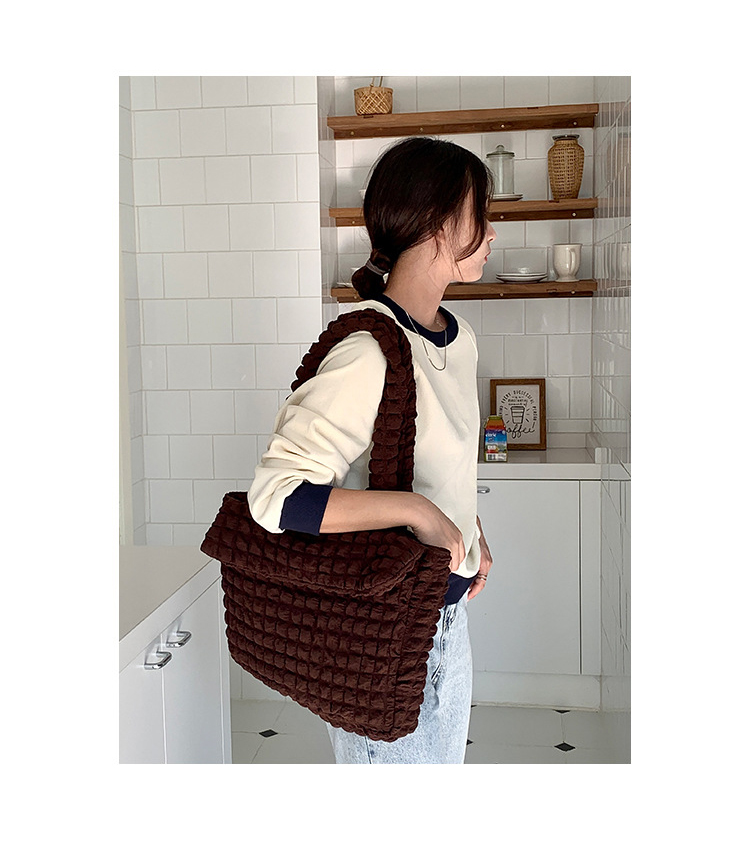A stylish Puffer Tote Bag featuring lightweight filling and durable material, with a unique quilted design and spacious interior. Perfect for everyday use and travel, combining practicality and fashion.