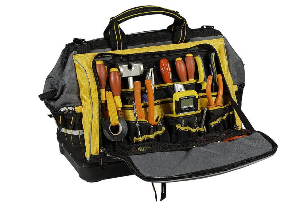 An organized tool bag with a cordless drill and hand tools.