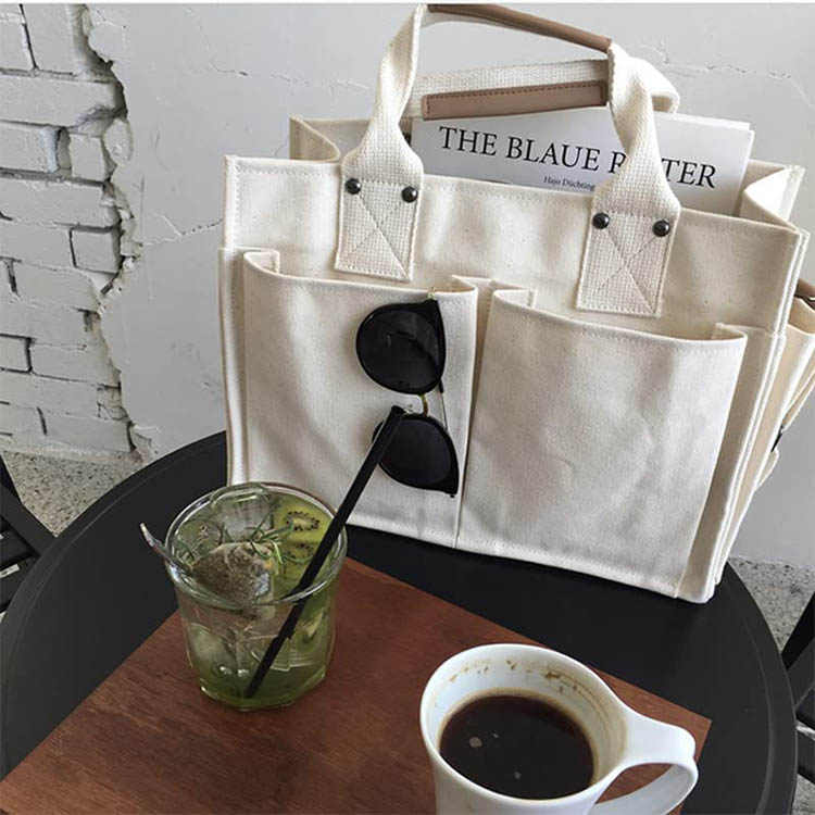 Explore the unique design features of large canvas tote with pockets, their versatile uses, and how XINHUI offers customizable options.