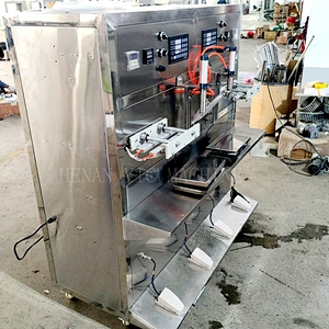 Double head liquid filling machine with heat sealer