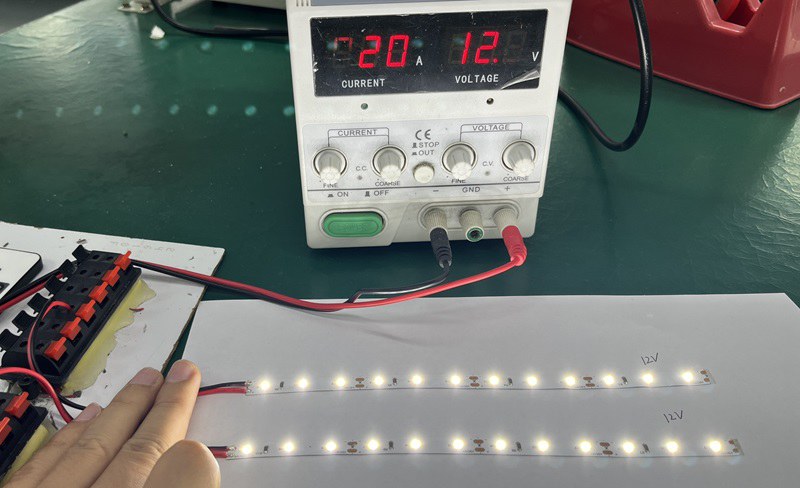 two identical 12V LED strips wired on a regulated 24V bench power supply