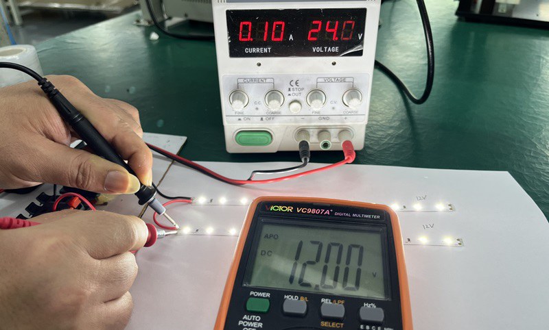 two identical 12V LED strips wired in series on a regulated 24V bench power supply