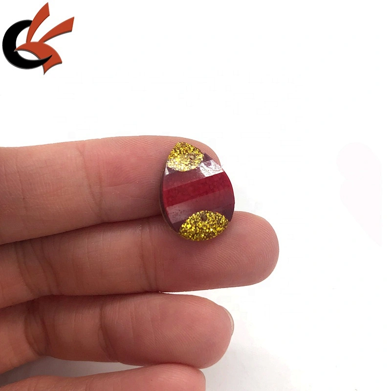 Red and gold glitter glue on resin loose stones