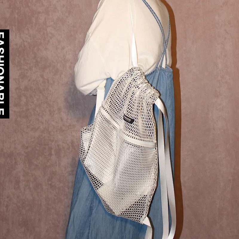 Foldable black poly fabric mesh drawstring sports bag with front zipper pocket