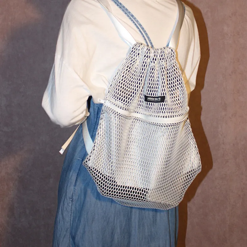 Foldable black poly fabric mesh drawstring sports bag with front zipper pocket