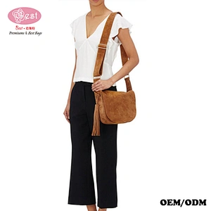 Hot Selling Designer Branded Pink Suede Leather Small Saddle Bag with Tassel Charm Hobo Bag for Lady
