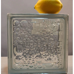 A hollow glass block with wavy water droplets