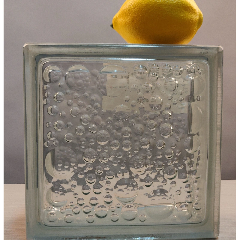 A hollow glass block with wavy water droplets