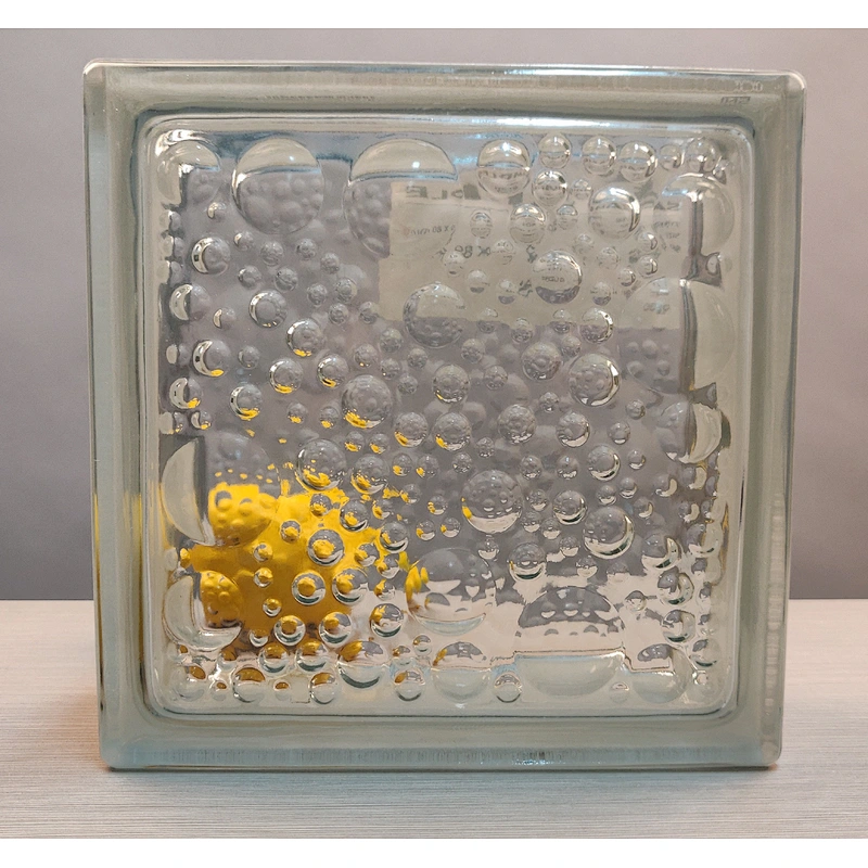 A hollow glass block with wavy water droplets