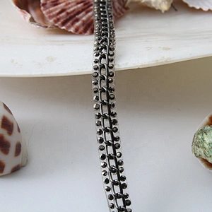 Accessories chain edging clothing trim with iron on melt adhesive backing applied to clothing