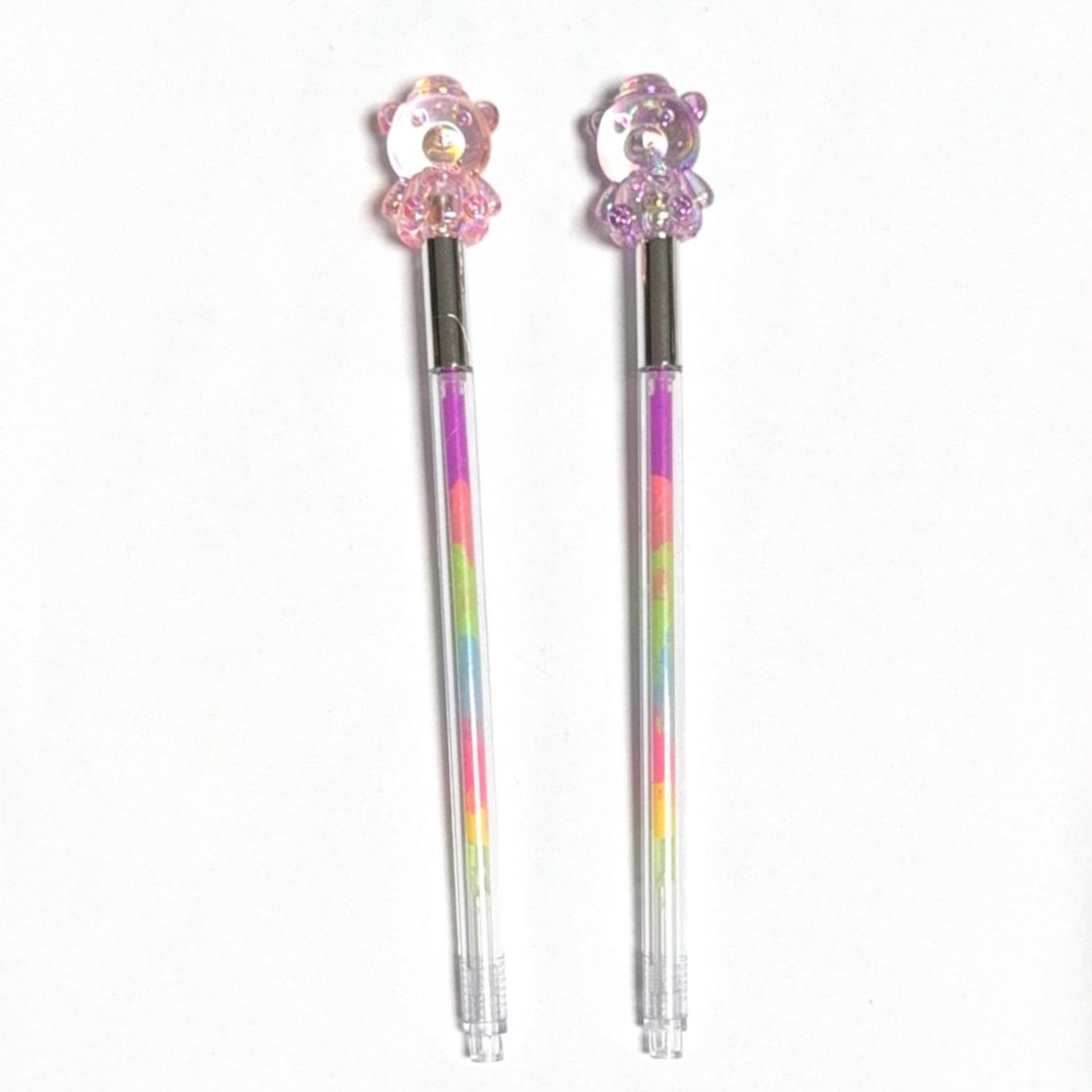 colored pen with a bear plush on top