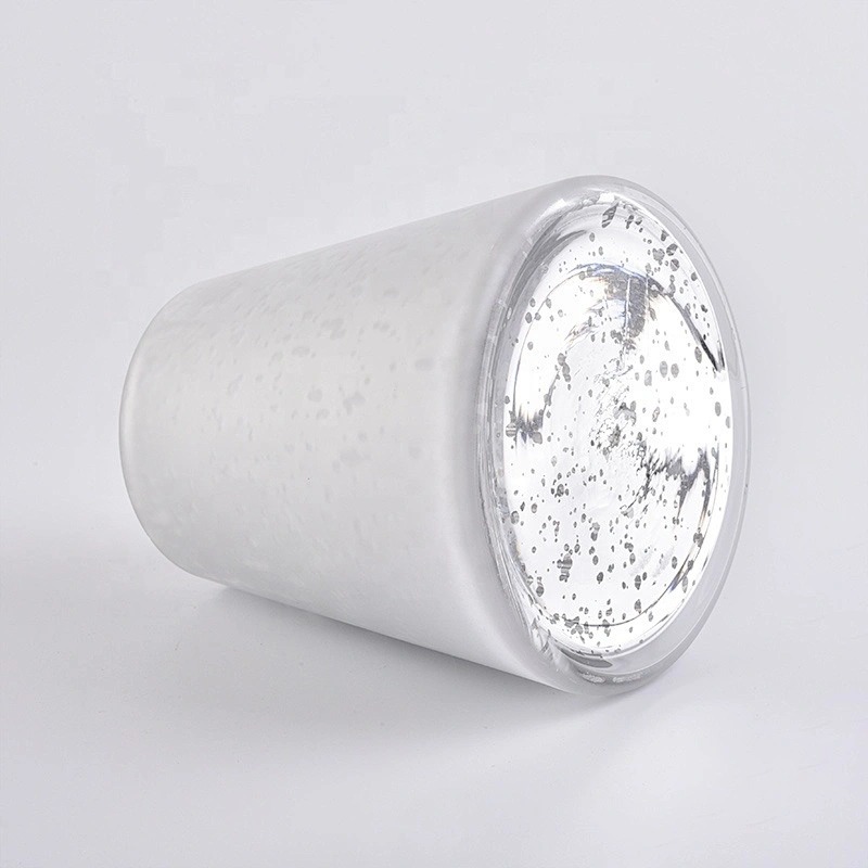 Large white glass candle vessels with mercury decorations