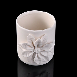 white ceramic candle vessel with flower