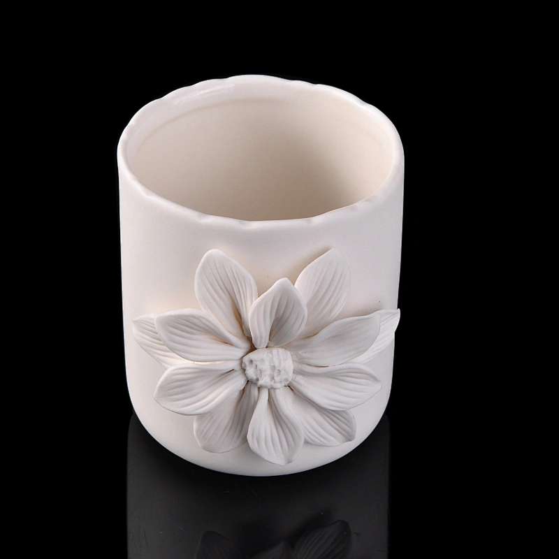 white ceramic candle vessel with flower