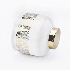 white ceramic candle jars with gold designs