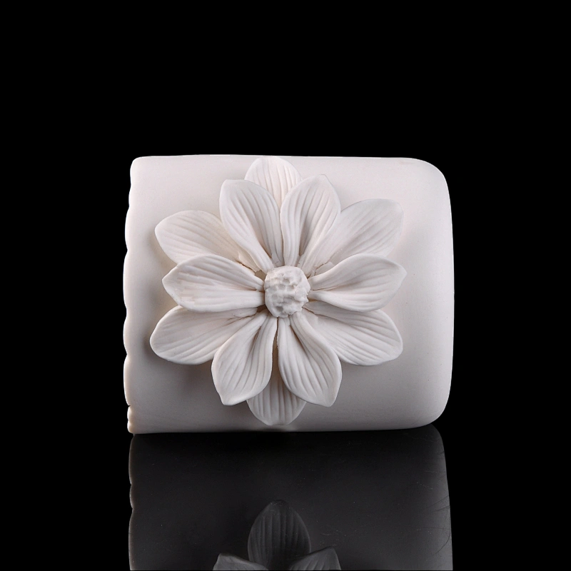 white ceramic candle vessel with flower