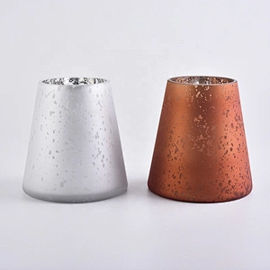 Large white glass candle vessels with mercury decorations