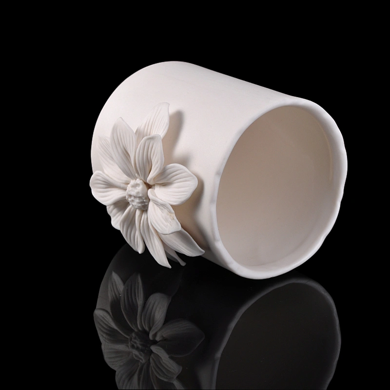 white ceramic candle vessel with flower